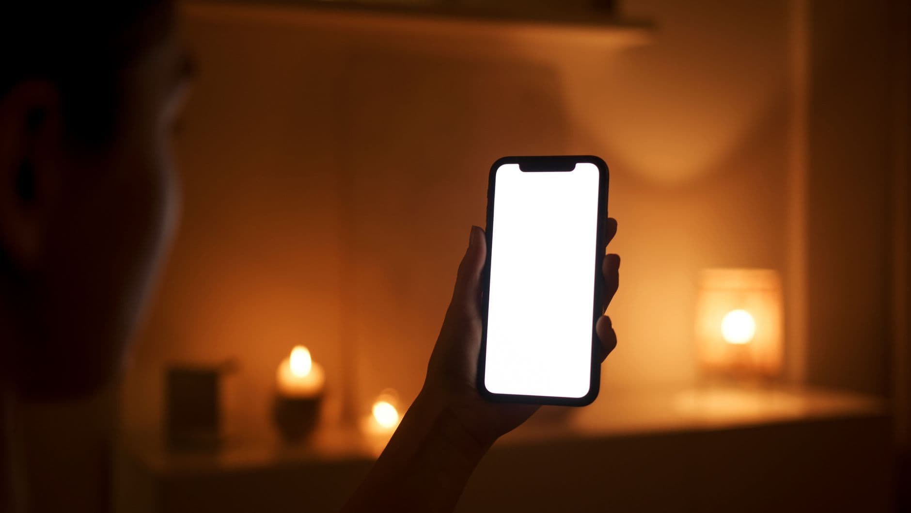 A phone screen lit in a dark room at night